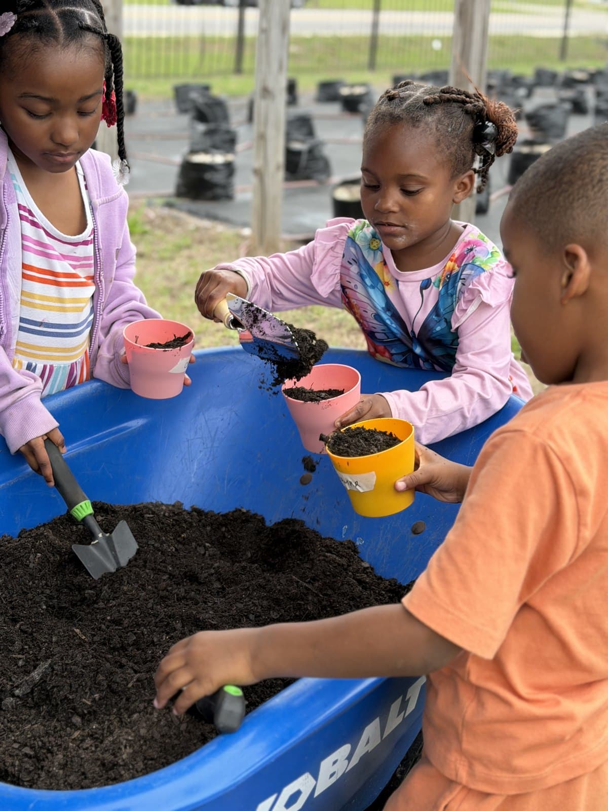 Young students planting together during a hands-on life-skills session