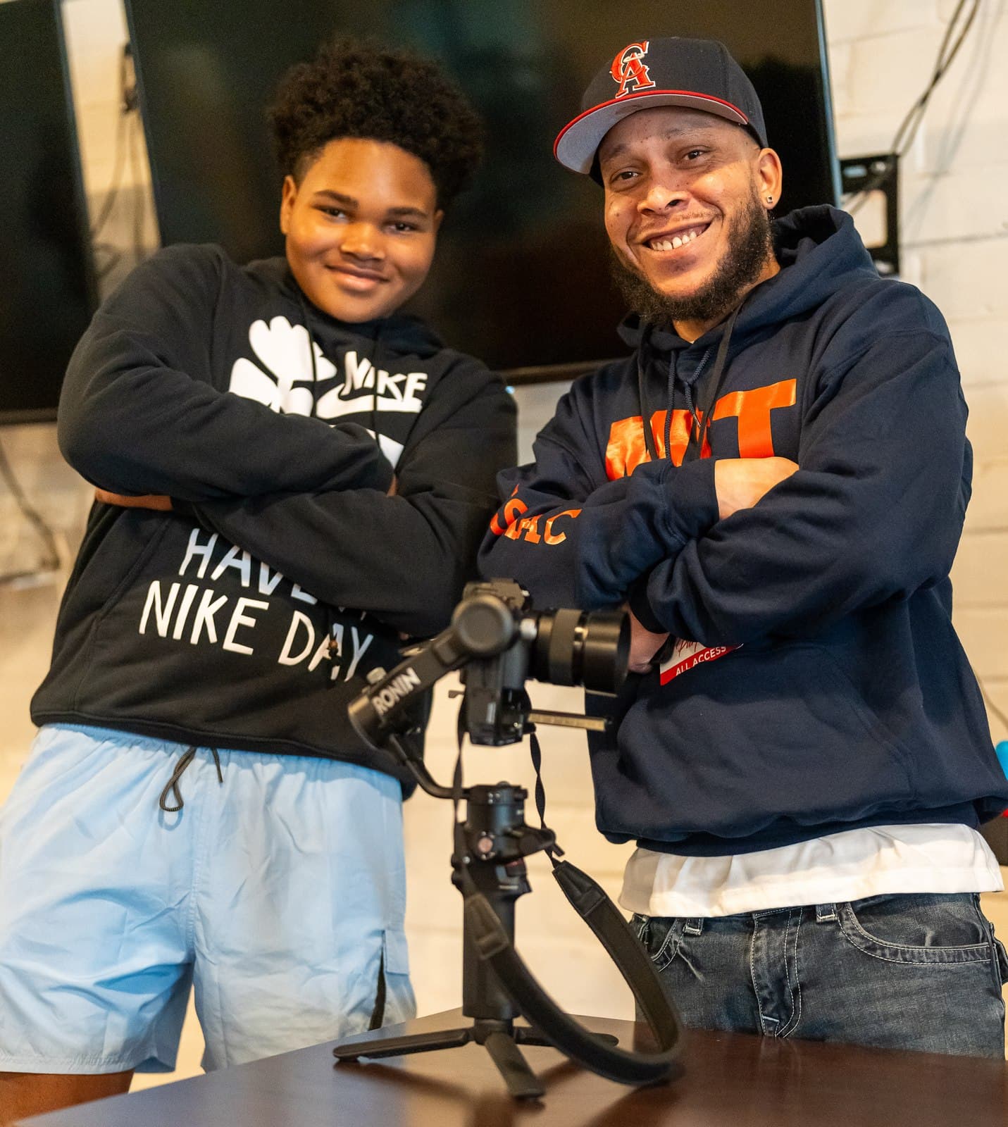 A Men in Training mentor and student together behind a camera