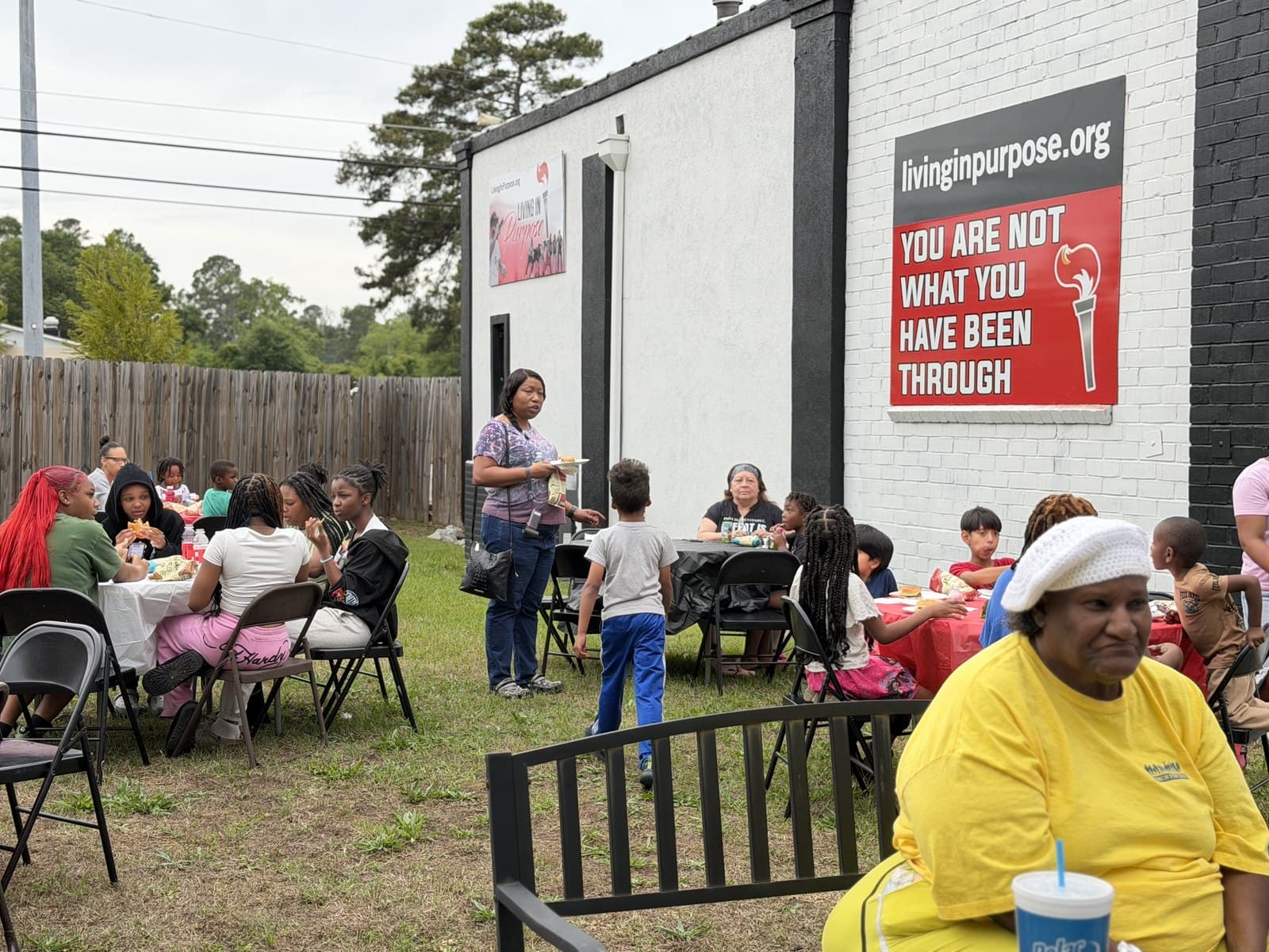 Neighbours gathered outside the Purpose Center on Olive Road