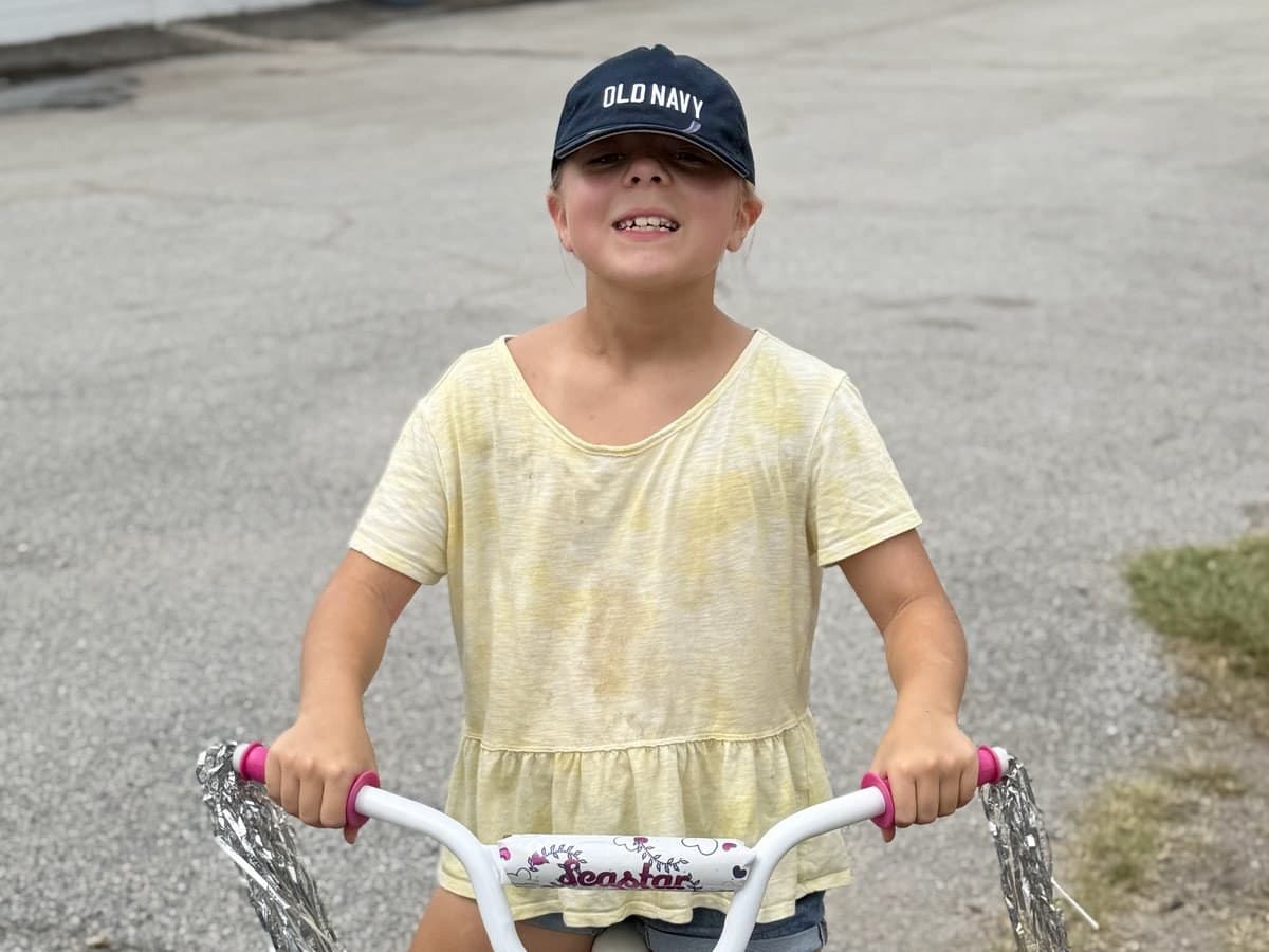 A young Living in Purpose participant on her bicycle in Augusta